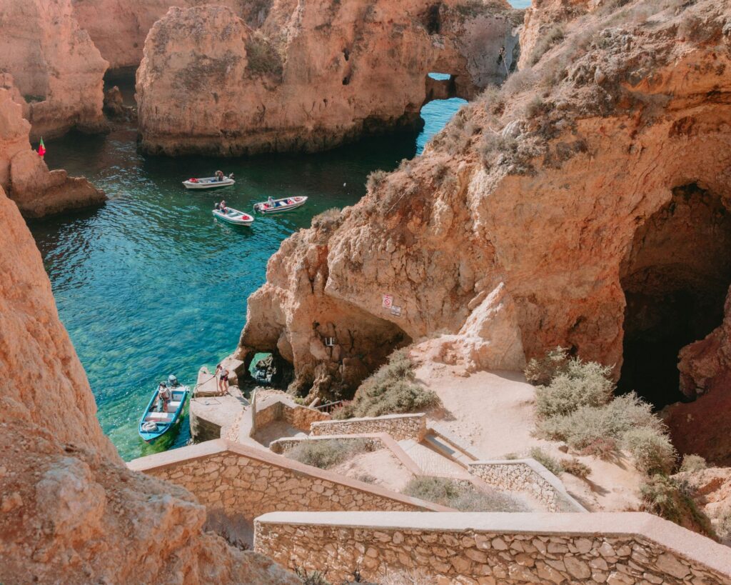 Sunlight shining through the natural skylight of Benagil Cave along the Algarve coast in Portugal.