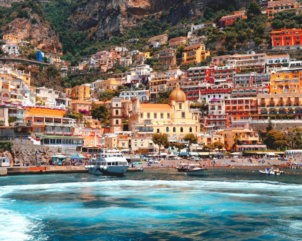 Colorful cliffside buildings overlooking turquoise water along the Amalfi Coast in southern Italy.