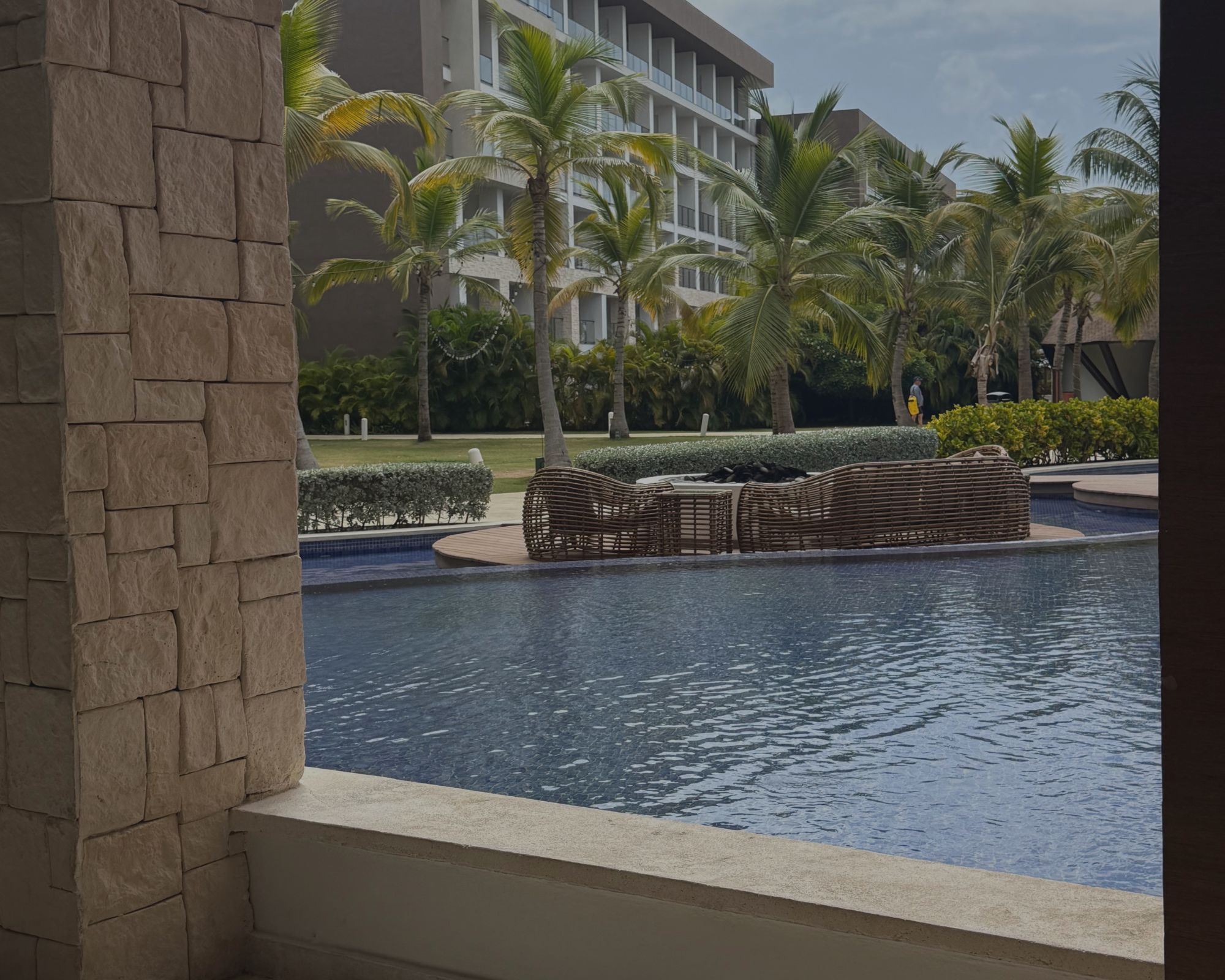 Infinity‑style pool at Hyatt Ziva Cap Cana overlooking palm trees and the Caribbean Sea.