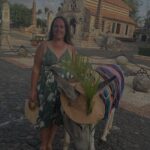 Woman standing with a donkey at Altos de Chavón in Casa de Campo, Dominican Republic.