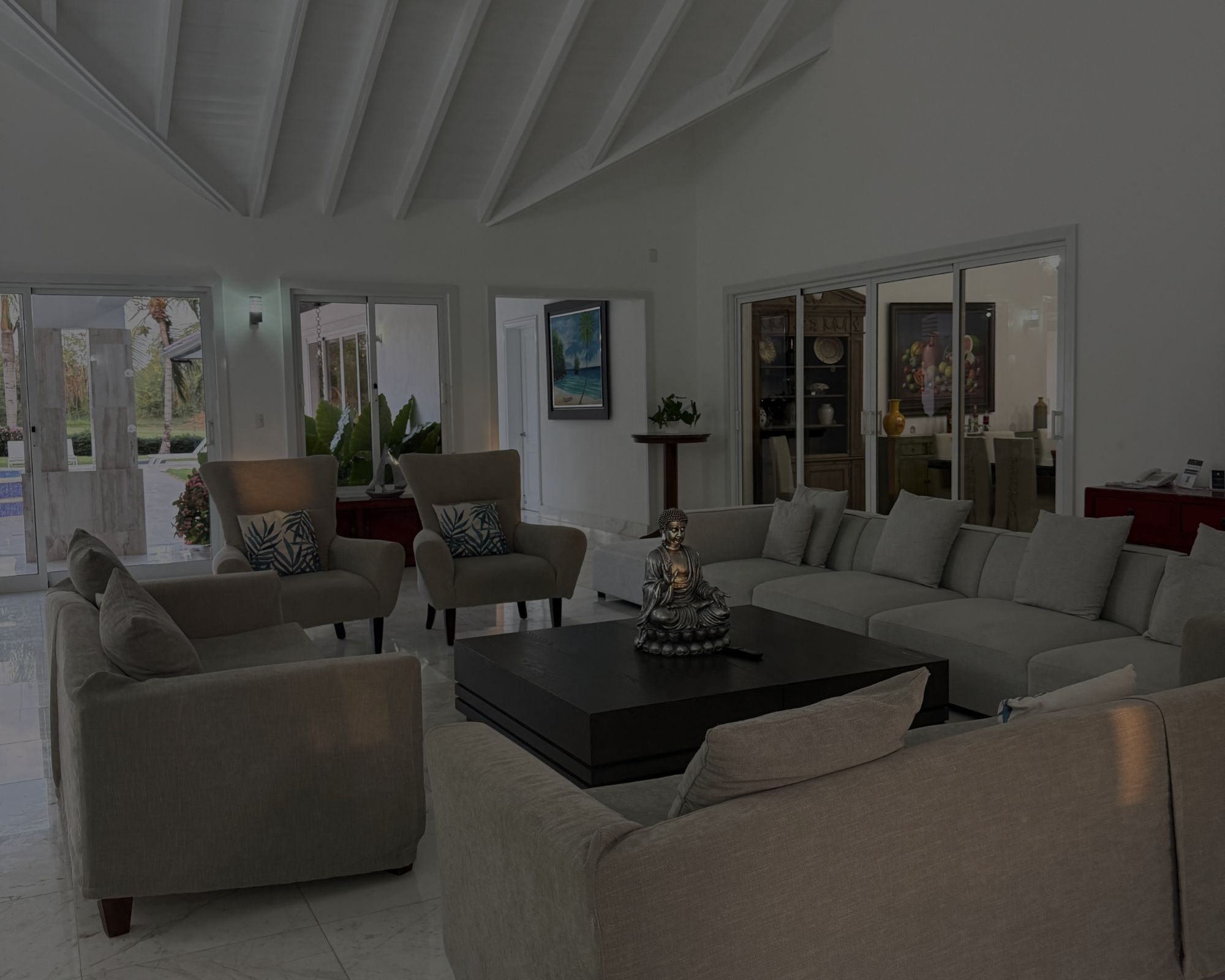 Luxury villa living room at Casa de Campo with modern furnishings, open layout, and tropical views.